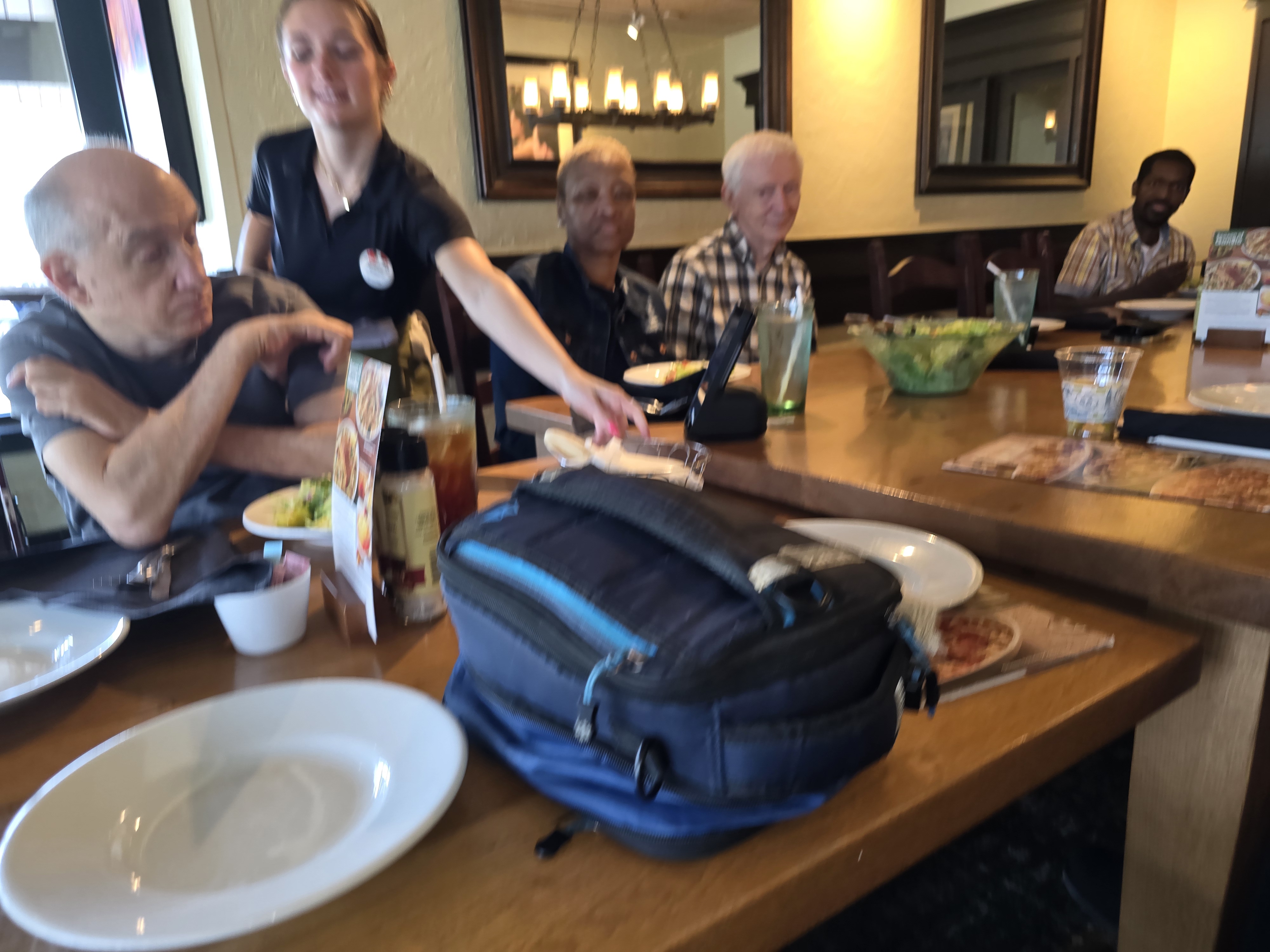 Spinal injury support group out to eat at Olive Garden. Robert, Kim, Jim, and Chris are all in the photo.