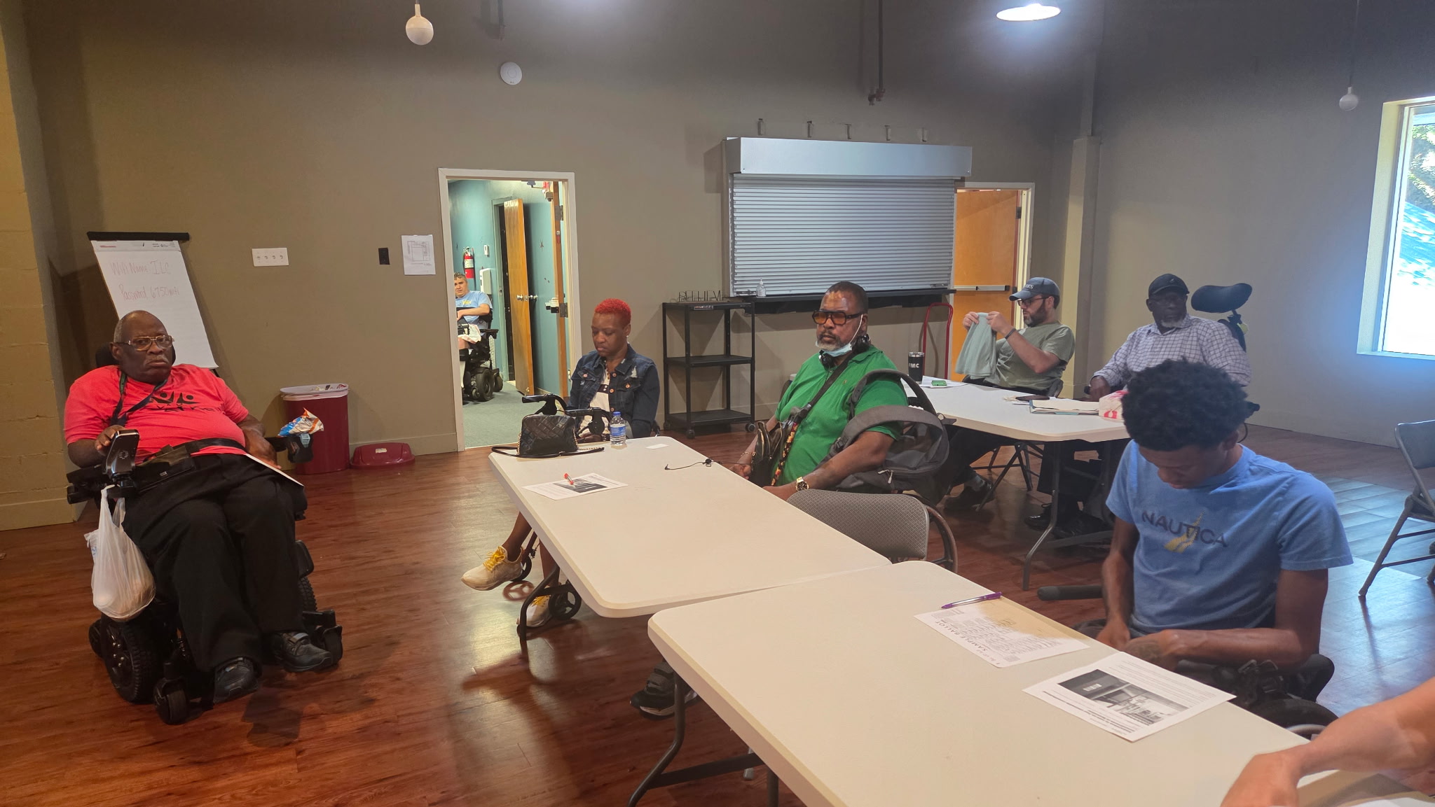 Spinal Cord Injury Support Group members gathered around tables during their September 2026 meeting.