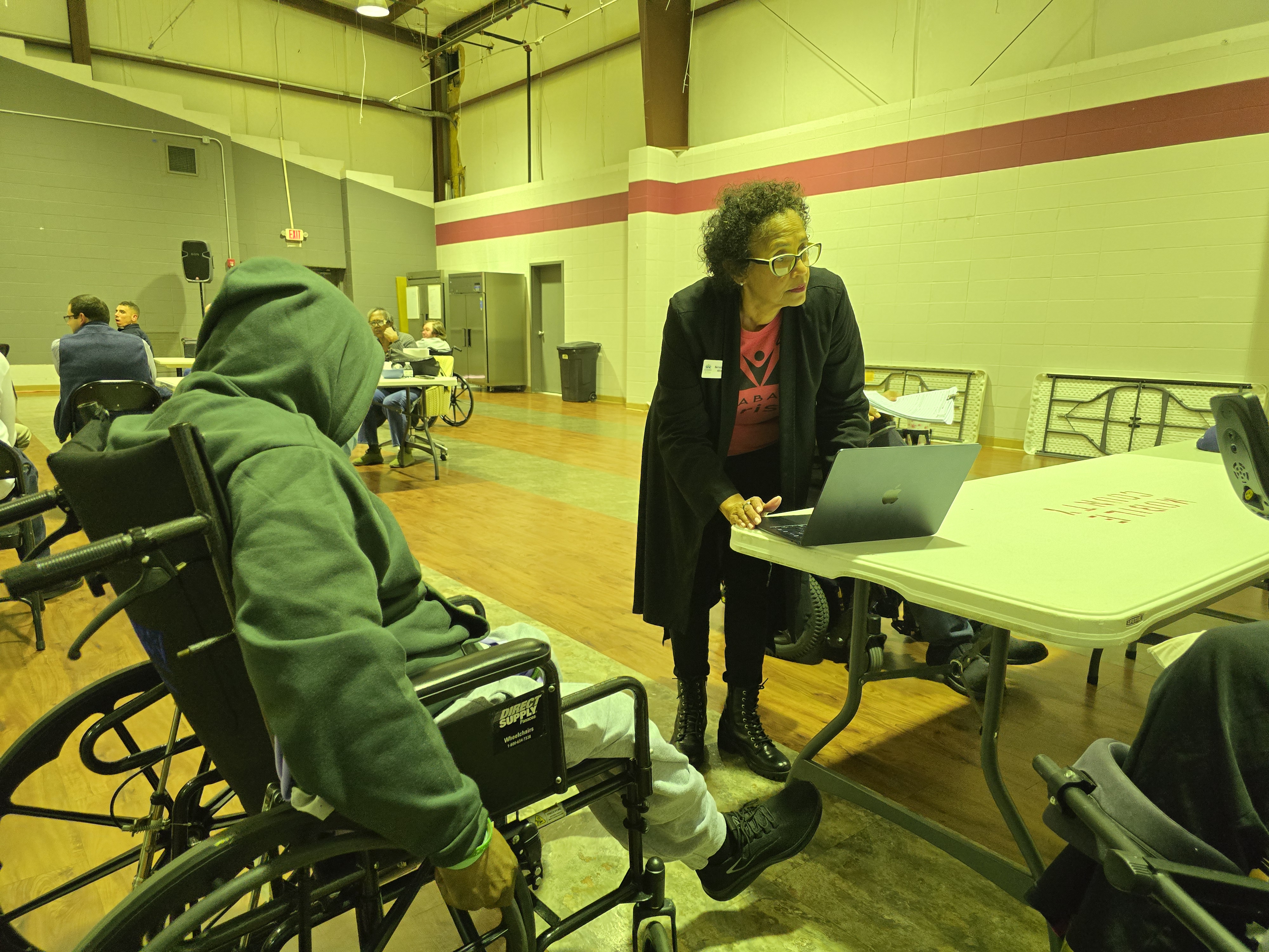 Alabama Arise member registering a group member for the February 24th Legislative day at the table.