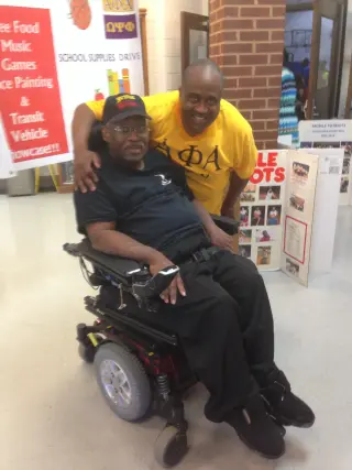 Brian Johnson cheering courtside at wheelchair-basketball game