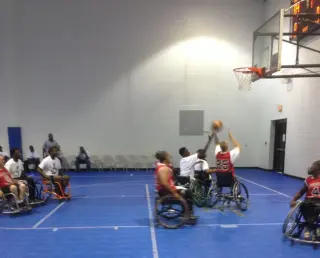 Full-court wheelchair basketball action sponsored by Mobile Wave Transit